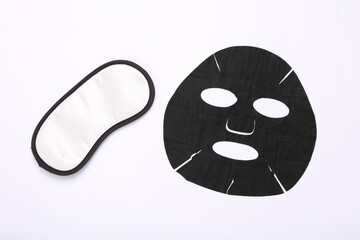 Black cosmetic cleansing mask and sleeping mask on white background