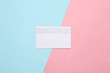 Fototapeta na wymiar White bank card on blue pink pastel background