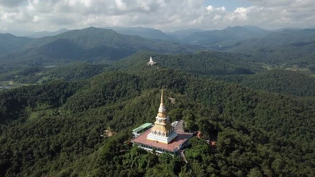 Aerial view of the large pagoda in Wat Phrathat Mon Phrachao Lai temple located on mountain elevation above seal level is 618 metres in Chiang Rai province, Thailand.