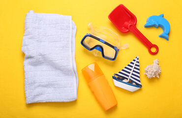 Composition with children's beach objects on yellow background. Top view. Flat lay. Sea vocation