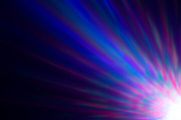 Colorful rays of light or light beams at dark. Abstract high resolution blurry background.