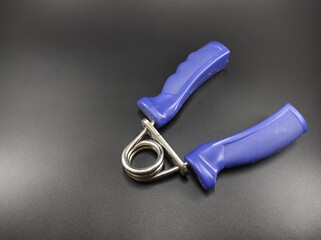 Photo of a hand grip training device isolated on a black background, Not Focus