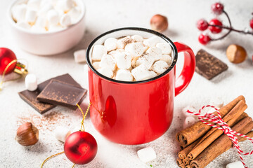 Hot chocolate with marshmallow in red mug. Traditional winter drink.