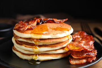 Delicious pancakes with maple syrup and fried bacon on plate, closeup - obrazy, fototapety, plakaty