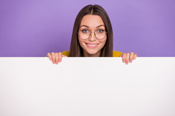 Photo of young lovely girl demonstrate announcement promo advert isolated over purple color...