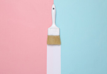 Paint brush with white stripe on a blue pink background. Minimal layout. Top view