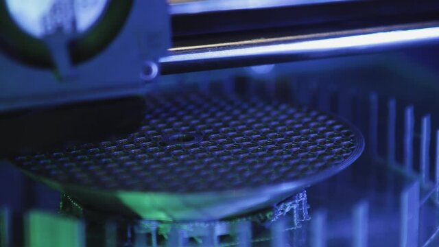 3D printer working close-up. High-tech fast printing of bulk plastic parts with heated polymer materials. Machine creates a modern prototype object