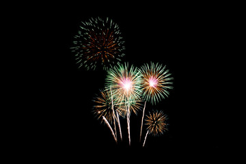Fototapeta premium Many flashing colorful fireworks in event amazing with black background celebrate New Year, holiday and festival in night.