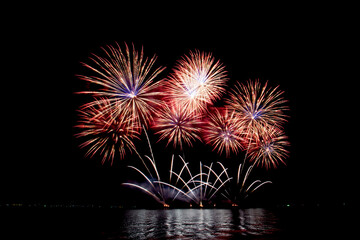 Many flashing colorful fireworks in event amazing with black background celebrate New Year, holiday and festival in night.