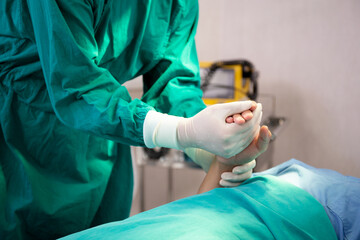 Hands of doctor holding with patient for encourage and trust at hospital, surgeon encouragement patient before surgery for healing with emergency in the operation room, medical and health concepts.