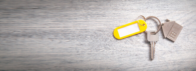 House key on the white wooden background.