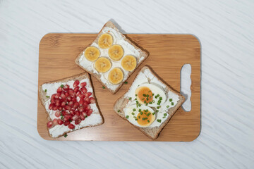 Bread has cream cheese and pomegranate boiled egg banana on white background.