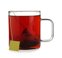 Tea bag in glass cup of hot water isolated on white