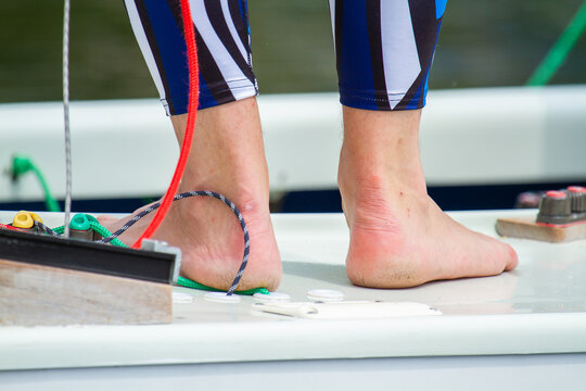 Bare Feet Of A Man On The Deck Of A Ship.
