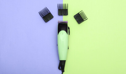 Hair clipper with attachments on pink blue pastel background. Top view