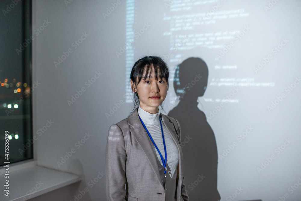 Aufkleber young asian businesswoman in formalwear standing by interactive whiteboard with coded data during pr