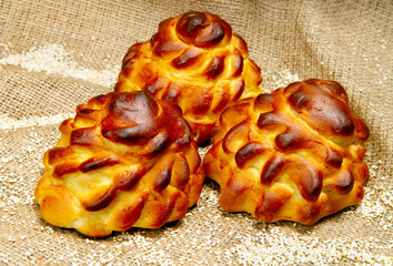 Sweet buns with sesame seeds on a burlap background.
