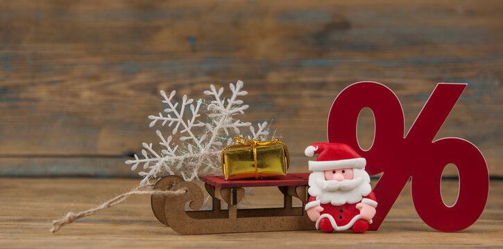 Santa Claus and sign percentege on wood background Merry Christmas. Happy New Year
