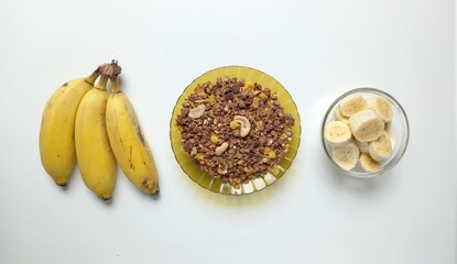 Banana with granola. White background. Chopped banan. Banana Cluster. 