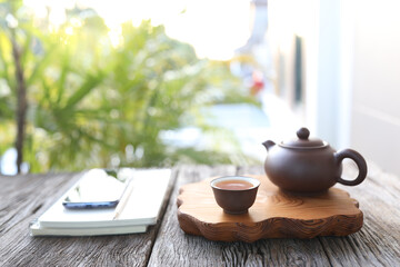 Tea pot and tea cup and notebook
