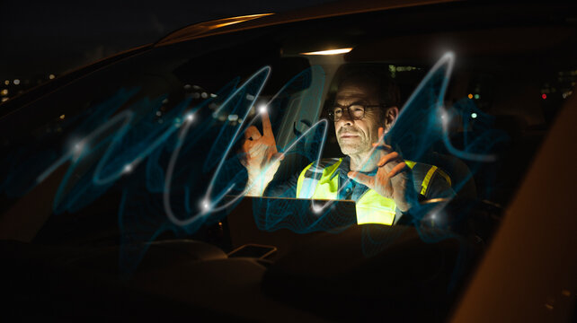 Engineer touching glowing waves in car