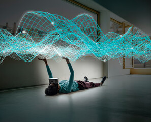 Businesswoman touching digitalized waves on floor