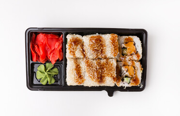 Rolls in black plastic box, japanese food as fast food, isolated on white.