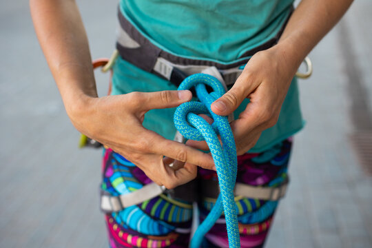 rock climber tying a safety knot