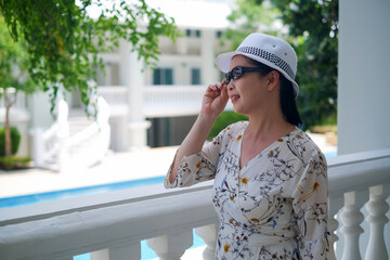 portrait senior asia woman wear a hat in garden