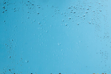 Blue backgrond with water drops. Wet glass.