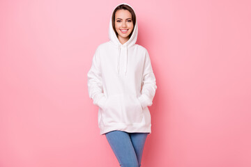 Photo of pretty cute young woman dressed white sweatshirt arms pockets smiling isolated pink color background