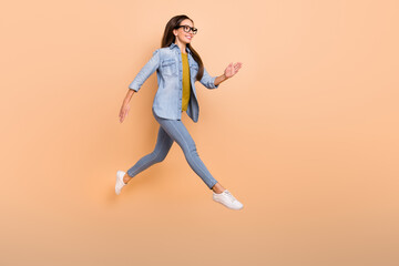 Fototapeta na wymiar Full size profile side photo of smiling businesswoman running fast hurry work isolated on beige color background