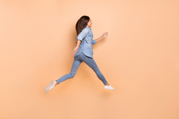 Fototapeta na wymiar Full size profile side photo of young woman traveling running fast look copyspace isolated on beige color background