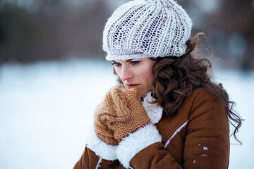 stressed modern woman outside in city park in winter