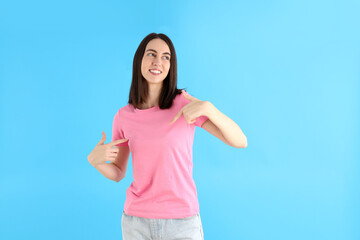 Young attractive woman in t-shirt on blue background
