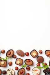 Flat lay composition with chocolate candies on white background
