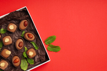 Concept of sweets with chocolate candies on red background