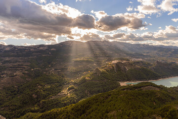 Sunbeams through the clouds over the mountains.