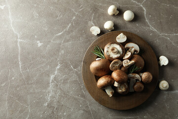 Concept of tasty food with champignon on gray textured background