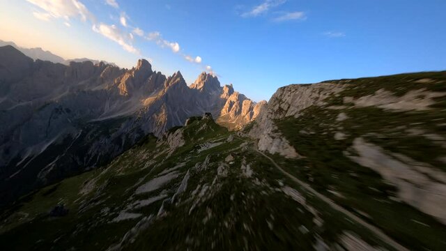 FPV drone aerial view of Tre Cime di Lavaredo with clouds, Dolomiti di Sesto, South Tirol, Dolomiten mountains view, Italian Alps