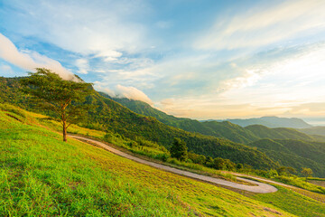 Naklejka premium mountain and sky view in the morning,The first or last rays of the sun on a mountain pass. Morning and evening in nature. Colorful sunset and sunrise over the mountain hills.