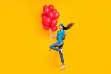 Fototapeta na wymiar Full size profile side photo of young excited teenager girl show v-symbol many balloons festive isolated over yellow color background