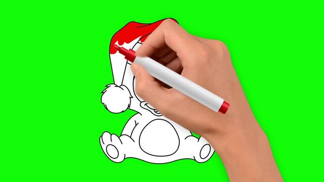 Christmas teddy bear is hand drawn on a green background. The bear is wearing a red Christmas hat.