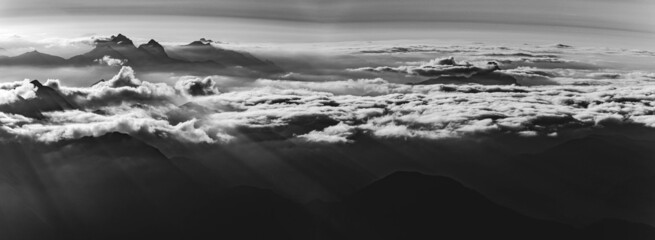 High resolution black and white panorama with dramatic clouds around the peaks at the famous...