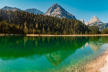 Fototapeta na wymiar High resolution panorama of an alpine summer view with reflections in a lake and mountains in the background at the Ehrwalder Alm near Ehrwald, Tyrol, Austria