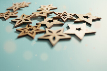 Close-up of Christmas stars, on a blue surface. Festive postcard.