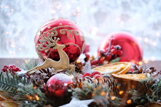 golden deer toy and Christmas  decor on blurred window background. symbol of new year and Christmas holidays. winter festive concept
