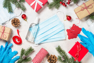 Christmas pandemic concept. Christmas decor, gifts and face mask and gloves. Safety concept. Be careful.