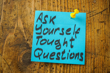 Pinned sticker with an inscription ask yourself tough questions.