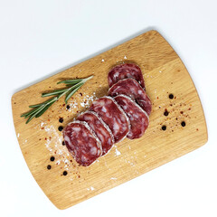 Top view delicious gourmet meat on the table. Salami sausage in white mold on a board